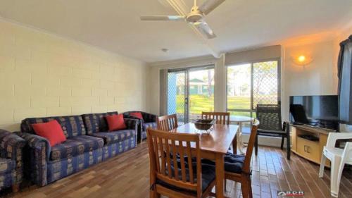 a living room with a couch and a table at Ocean Views in Burrum Heads