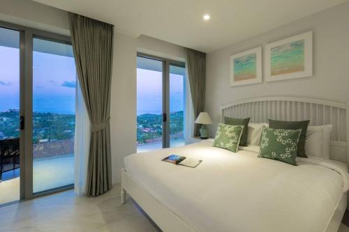 サムイ島にあるCobalt Suite Sea View Apartmentのベッドルーム(大きな白いベッド1台、窓付)