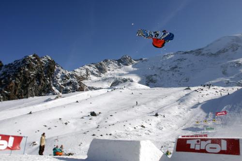 a person flying through the air while riding a snowboard at Hotel Tia Apart in Kaunertal