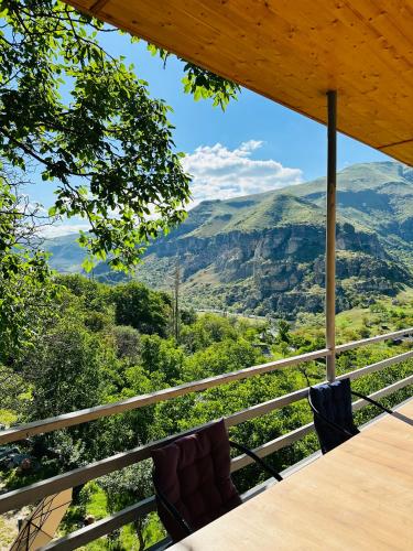 a table with chairs and a view of mountains at Hotel Vardzia Terrace in Vardzia