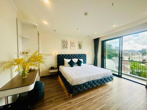 a bedroom with a bed and a large window at Memory Inn - Valley View in Xuan An