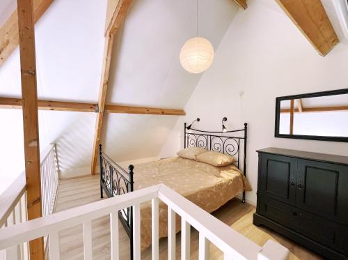 a bedroom with a bed in a room with a staircase at Uylkenshof safaritenten en natuurhuisjes in Epe