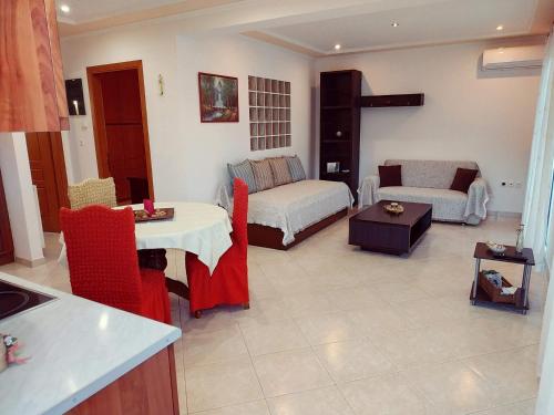 a living room with a bed and a couch at Central Moudros apartments in Moudhros