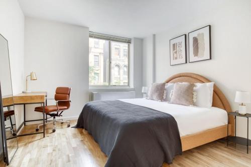 a bedroom with a bed and a desk and a chair at UWS 1br w doorman gym nr Central Park NYC-932 in New York
