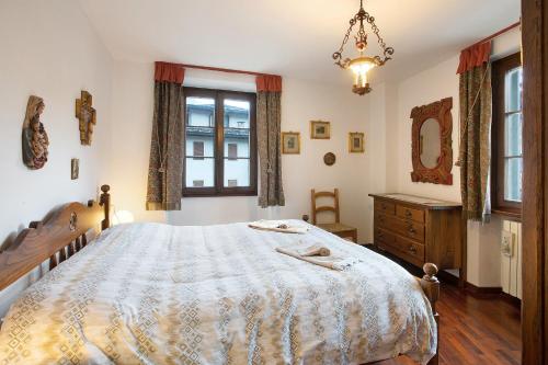 a bedroom with a bed and a dresser and a window at Bormio 3 in Bormio