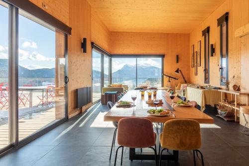 une salle à manger avec une table et des chaises et une grande fenêtre dans l'établissement Une des plus belles vues de la Drôme, à Teyssières