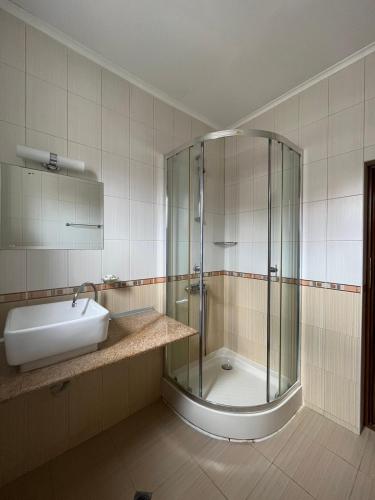 a bathroom with a shower and a sink at Апарт Хотел Мари in Ravda