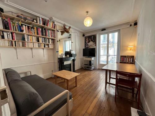 a living room with a couch and a table at Apartment near Montmartre(2 rooms!) in Paris