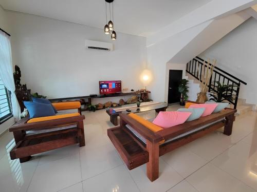 a living room with two couches and a tv at Malacca City Center Town House by 360HOME in Melaka