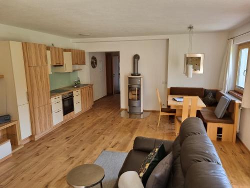 a living room and kitchen with a couch and a table at Ferienwohnungen Strass im Zillertal in Strass im Zillertal