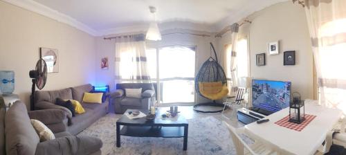 a living room with a couch and a table at LA vista topaz in Ain Sokhna