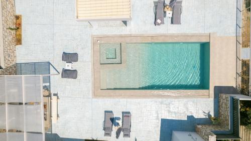a swimming pool on the side of a building at Le Mar Villa in Vasilikos