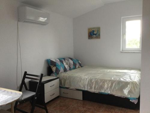 - une chambre avec un lit, une chaise et une fenêtre dans l'établissement Vila Roz, à Mangalia