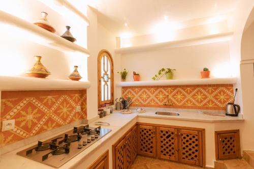 a kitchen with a stove and a counter top at Riad Villa with Mediterranean Sea Views of Spain and Gibraltar in Tangier