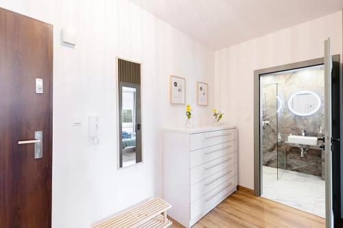 a white bathroom with a sink and a mirror at Korczaka2A in Kąty Wrocławskie