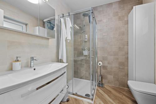 a bathroom with a shower and a sink and a toilet at Apartment Leone Medulin in Medulin