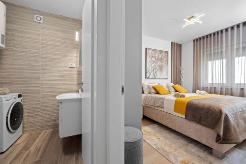 a bedroom with a bed and a washing machine at Apartment Leone Medulin in Medulin