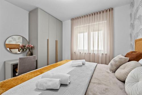 a bedroom with a large bed and a mirror at Apartment Leone Medulin in Medulin