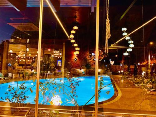 a large swimming pool in a building at night at Pamukkale Whiteheaven Suite Hotel in Pamukkale