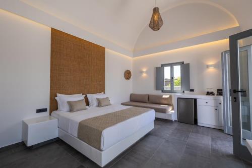 - une chambre blanche avec un lit et un canapé dans l'établissement Bonsai Luxury Suites, à Karterados