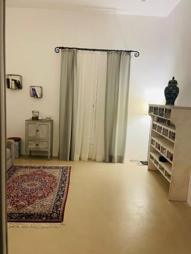a living room with a curtain and a rug at La Casa di Bacco B&b in Alezio