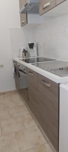 a kitchen with a sink and a counter top at APARTMAN KEVIN in Karlobag