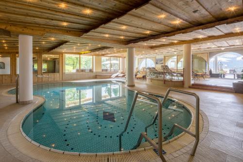 a large swimming pool in a building at Hotel Silberberger in Oberau