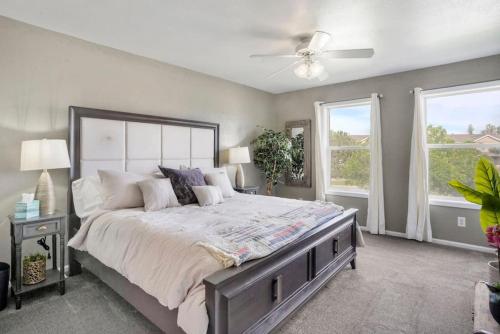 um quarto com uma cama grande e 2 janelas em 2 bed 2 and a half bath close to shopping restaurants and more em Pueblo