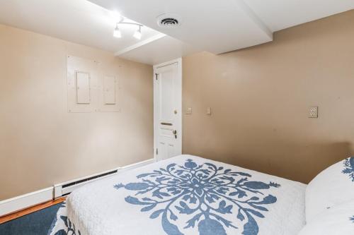 a bedroom with a bed with a blue and white blanket at Historic Petersburg Row Home in Petersburg