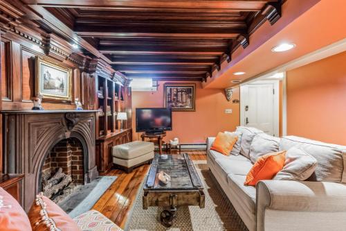 a living room with a couch and a fireplace at Historic Petersburg Row Home in Petersburg