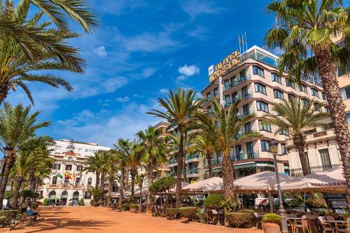 a hotel with palm trees in front of it at Hotel Marsol in Lloret de Mar