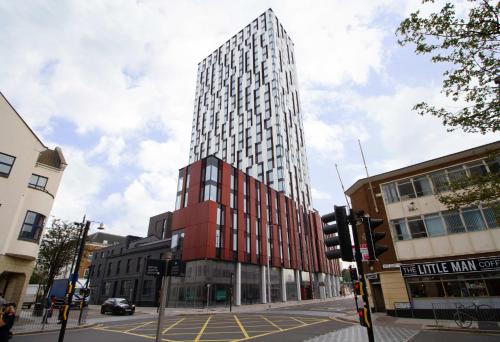 a tall red and white building on a city street at Bridge Street Cardiff in Cardiff