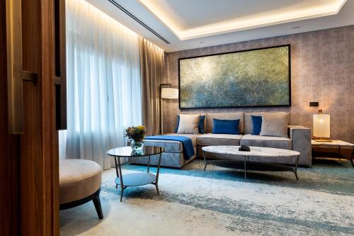 a hotel room with a bed and a couch at Wellington Hotel & Spa Madrid in Madrid