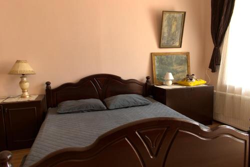 a bedroom with a bed and two night stands at STONE GARDEN 2 in Liepāja