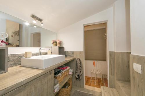 a bathroom with a sink and a mirror at La Poggiolina in Toscana in Guardistallo