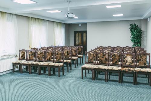 a row of chairs in a room with a wall at Dostyq Kokshetau in Kokshetau