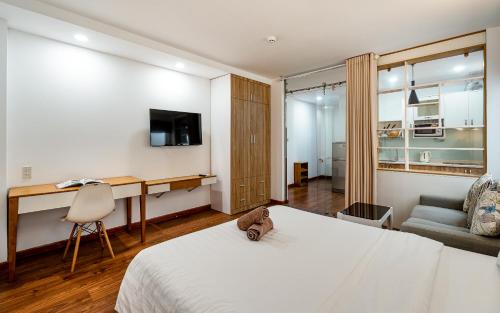 a bedroom with a bed with a teddy bear sitting on it at SaigonOne Serviced Apartment in Ho Chi Minh City