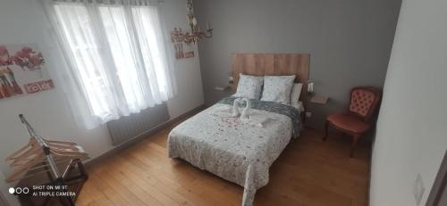 a small bedroom with a bed and a chair at VILLA CLARETTE in Carhaix-Plouguer