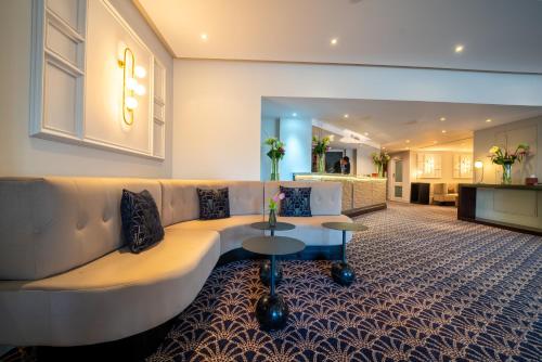 a living room with a couch and a table at The Winchester Hotel and Spa in Winchester