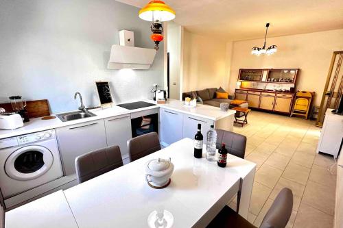 a kitchen and living room with a table and chairs at Under the Lemon Tree in La Caletta