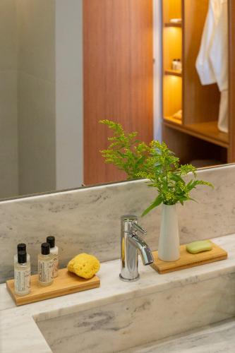 a bathroom counter with a sink and a mirror at Aquila Porto Rethymno in Rethymno Town