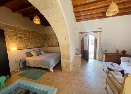 a bedroom with a bed and a tub in a room at B&B Monastiriako in Giannoudi