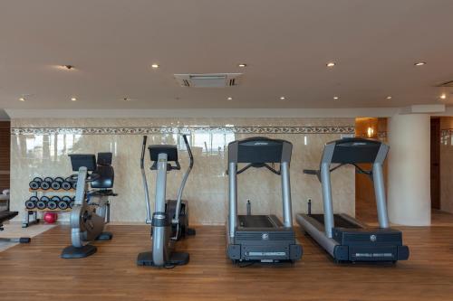 a gym with several treadmills and exercise bikes at Aquila Porto Rethymno in Rethymno Town