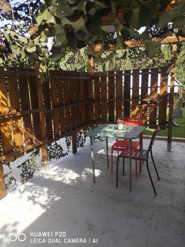 a table and two chairs sitting next to a fence at Loc126 in Montreuil-Bellay