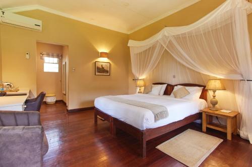 a bedroom with a large bed with a canopy at Aero Club of East Africa in Nairobi