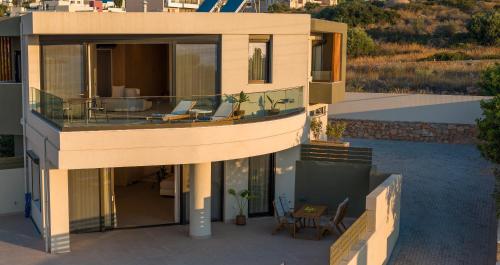 an aerial view of a house with a balcony at Anassa Ammoudi Suites in Agios Nikolaos