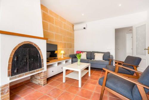 a living room with a couch and a fireplace at S Olivera in Port d'Addaia