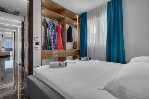 a bedroom with two beds and a closet at Lux Apartment Dolce Vita - Private HotTub in Makarska