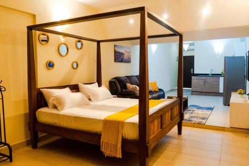 a bedroom with a canopy bed in a room at Beachside Bliss Studio in Ukunda