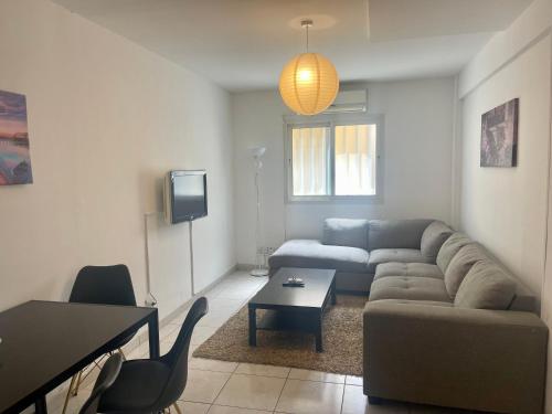 a living room with a couch and a table at Stephanie City Apartments in Larnaka